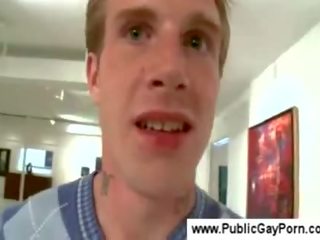 Public gay blowjob in an art gallery